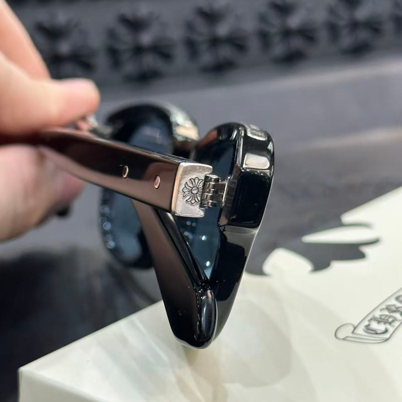 Крупный план серебряного декора шарнира с фирменным крестом Chrome Hearts