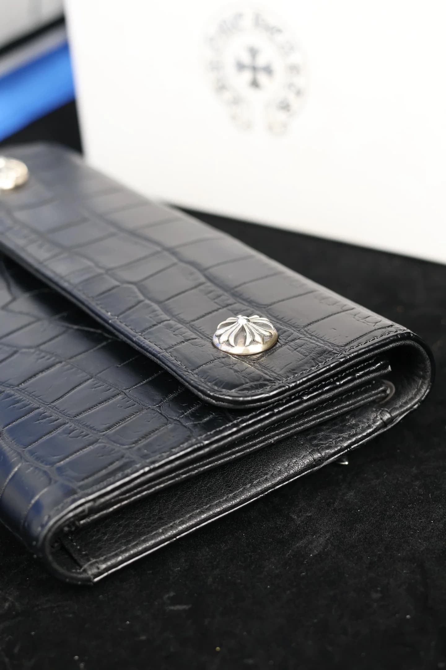 Фактура кожи крокодила и серебряные заклепки кошелька Chrome Hearts вблизи