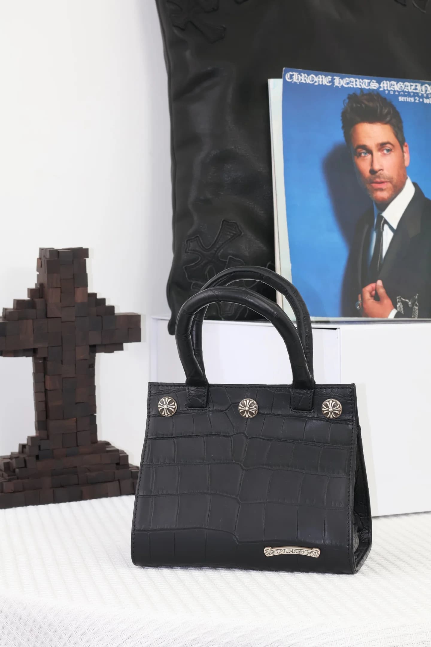 Фронтальный вид сумки Chrome Hearts с серебряной плашкой логотипа внизу
