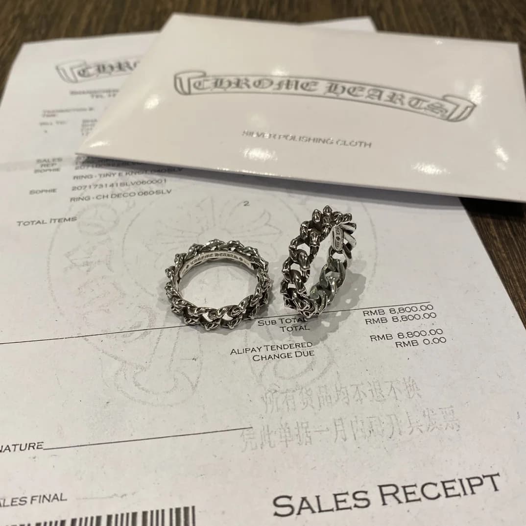 Серебряные кольца Chrome Hearts Chain на фоне фирменного чека и упаковки