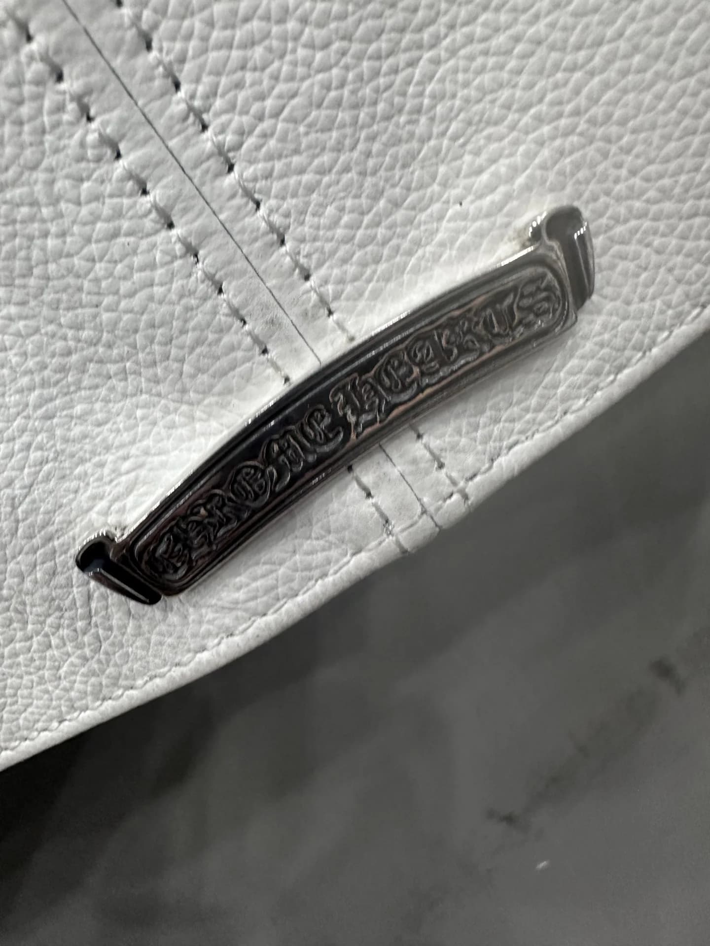 Металлическая пластина с гравировкой Chrome Hearts на куртке