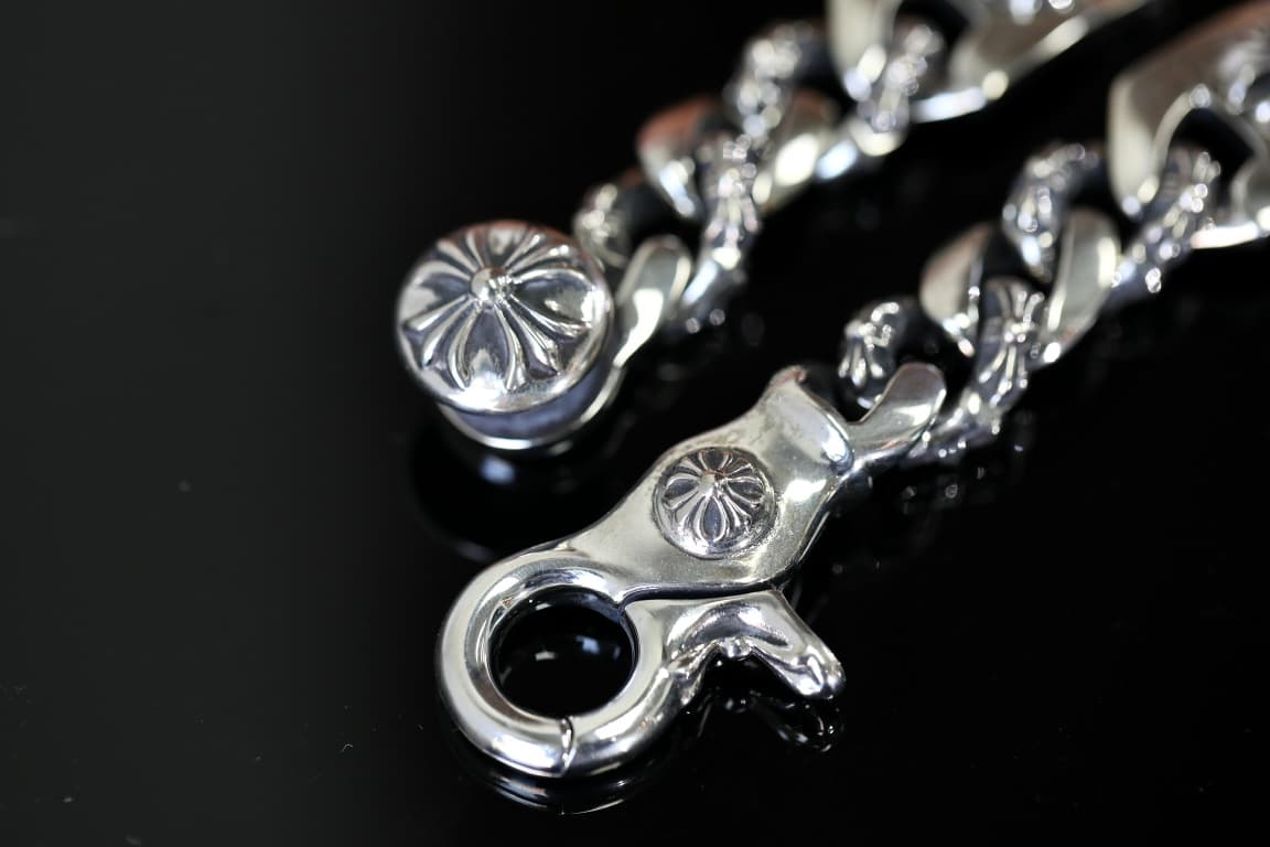 Крупный план замка-карабина серебряного браслета Chrome Hearts с крестом Floral Cross