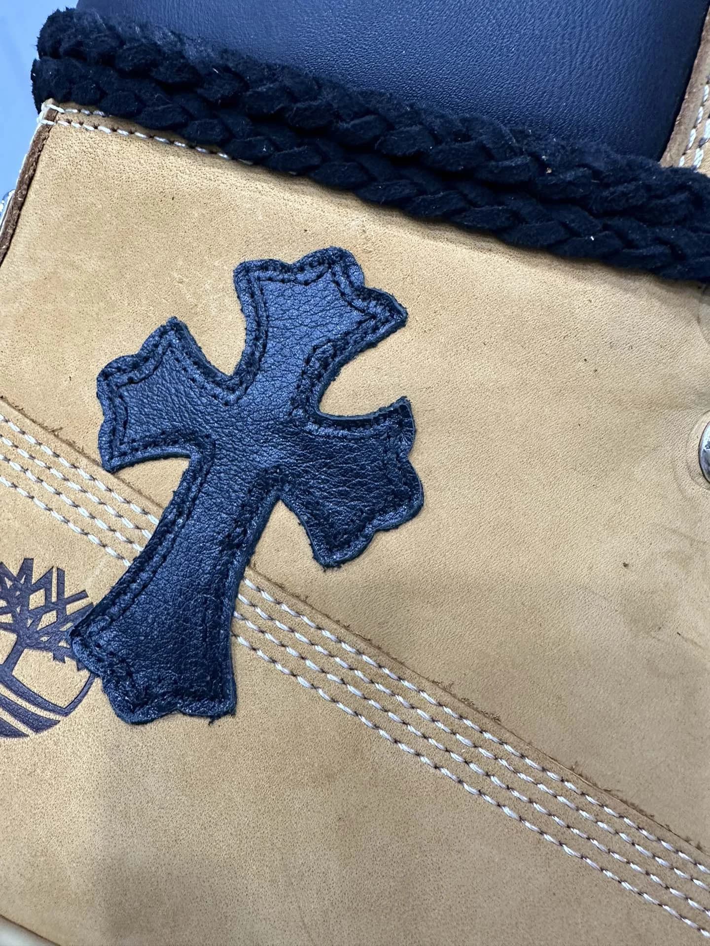 Крупный план кожаной нашивки-креста на ботинках Chrome Hearts x Timberland