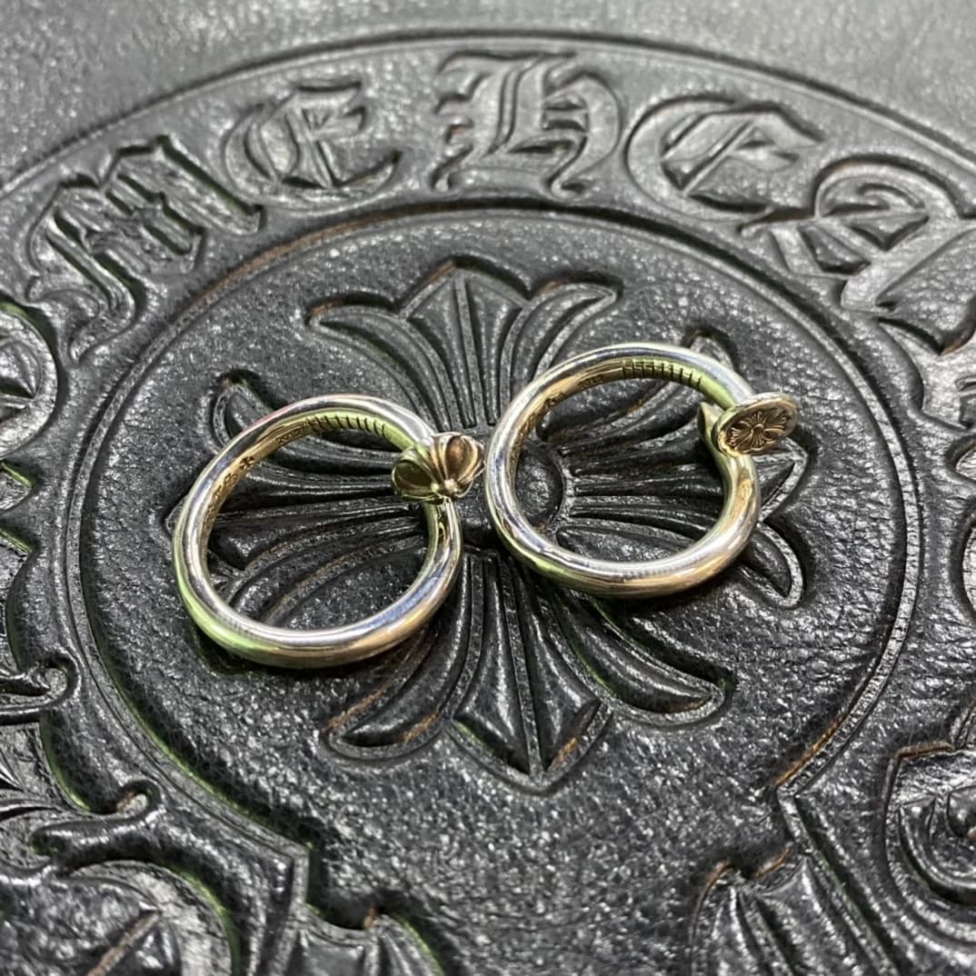 Два варианта дизайна кольца Chrome Hearts Nail на фирменном фоне