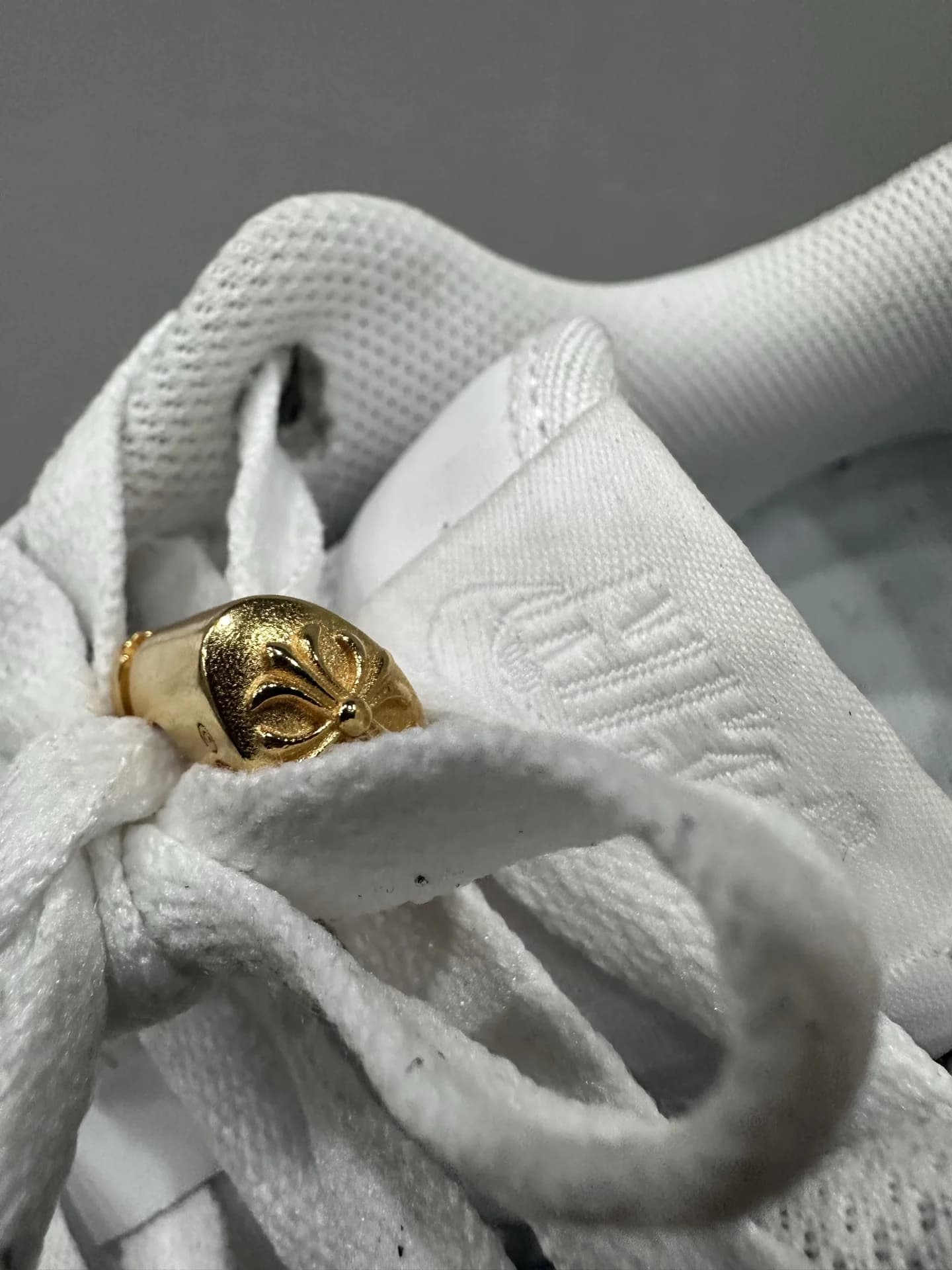 Деталь шнуровки белых кожаных кроссовок Chrome Hearts x Nike Air Force 1 Matty Boy с золотистым элементом