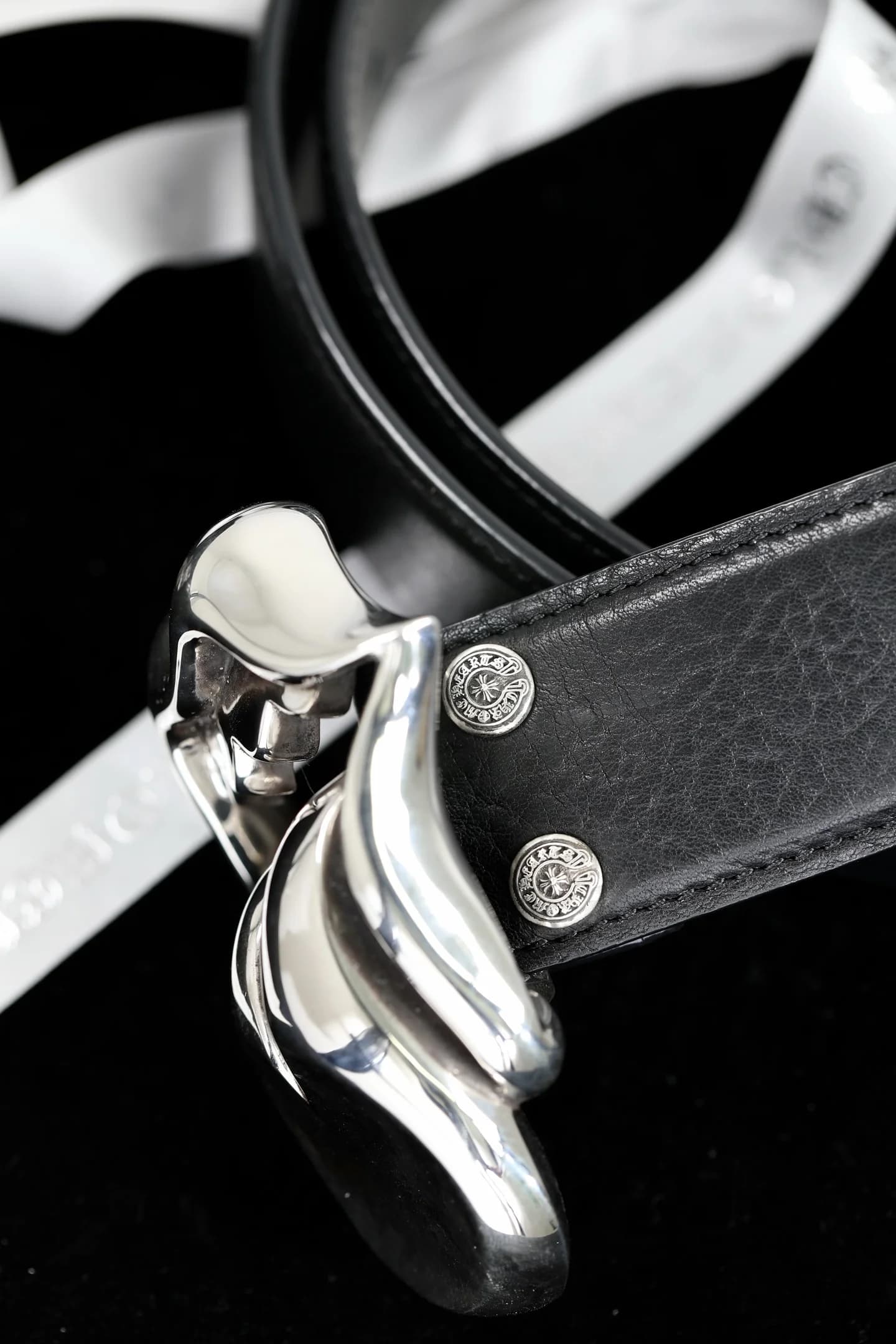 Вид сбоку на пряжку Lips and Tongue и заклепки ремня Chrome Hearts