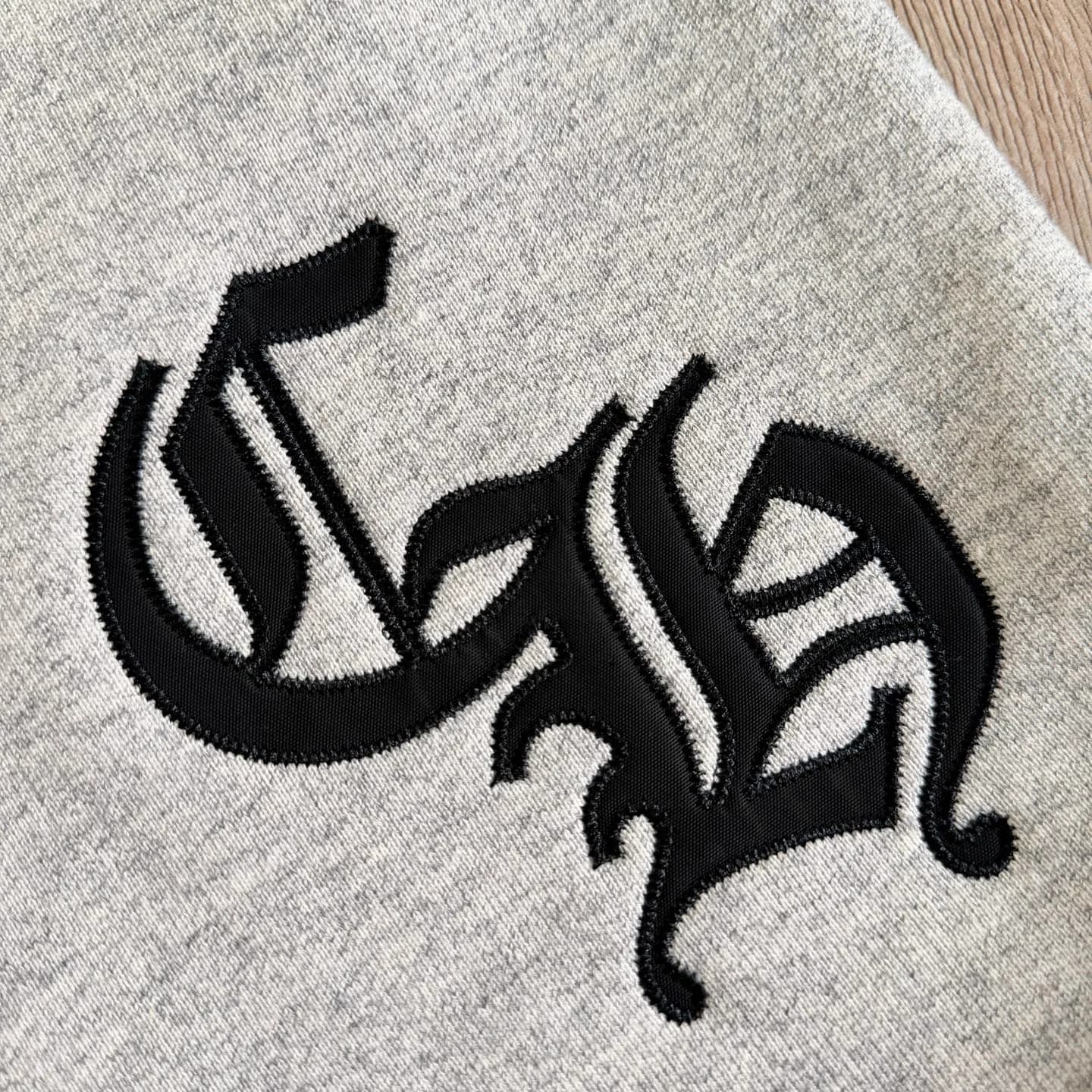 Деталь вышивки аппликации CH на шортах Chrome Hearts