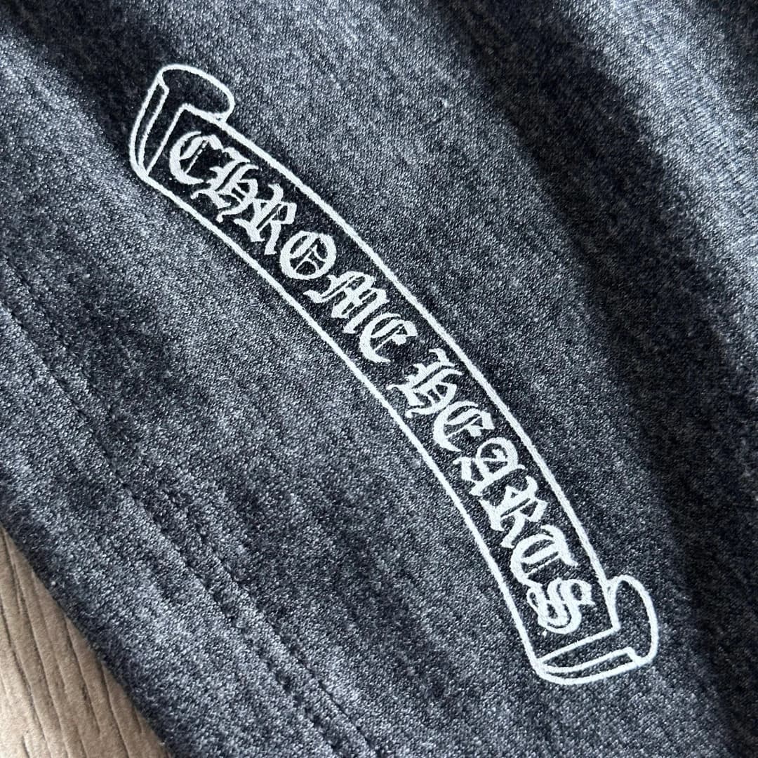 Крупный план готического принта Chrome Hearts на серой футболке