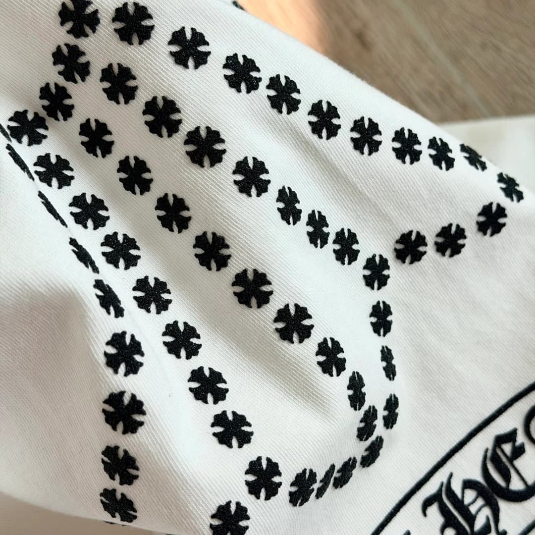 Крупный план принта в виде креста на белом лонгсливе Chrome Hearts