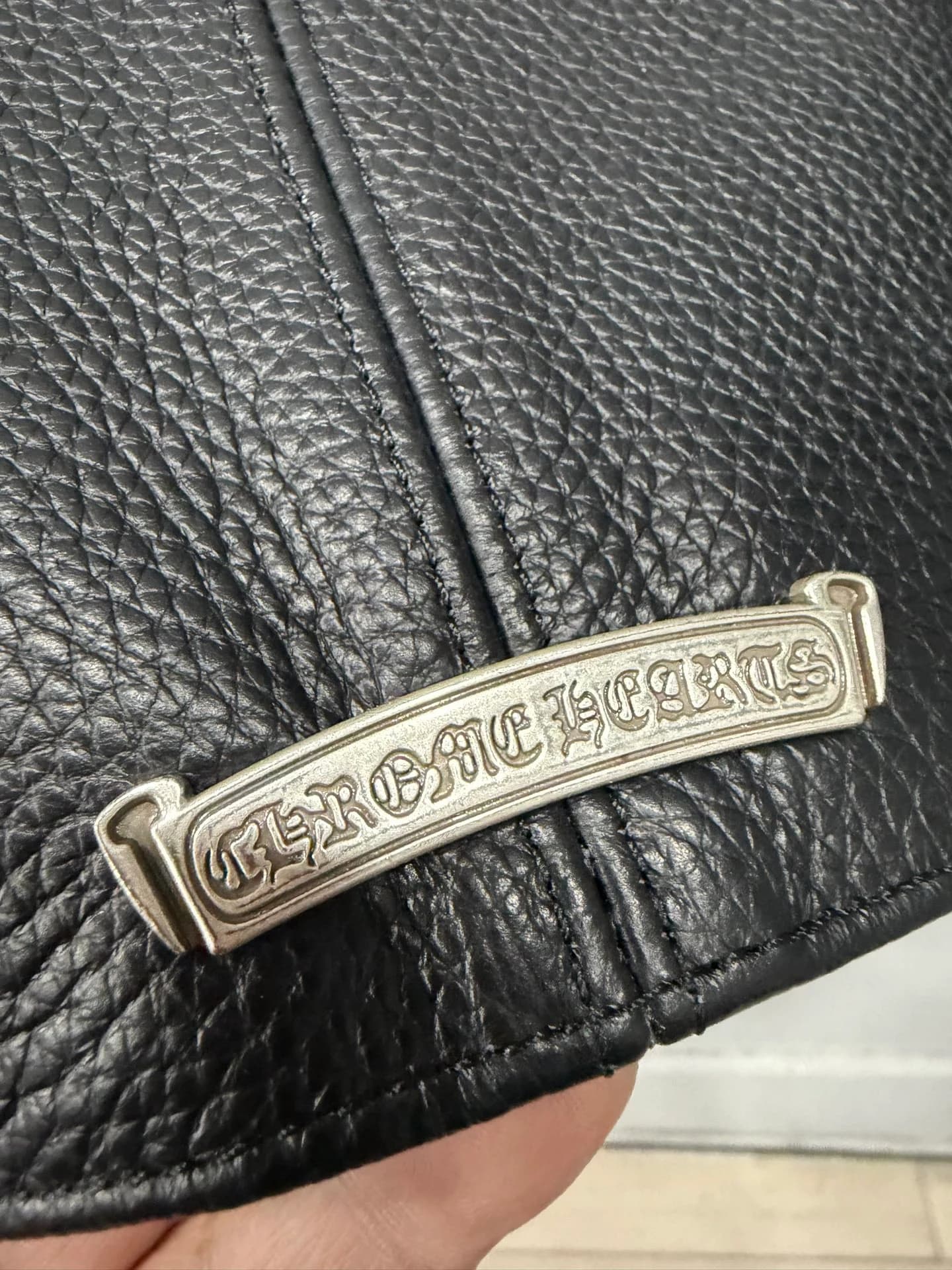 Металлическая плашка с логотипом Chrome Hearts на спинке куртки