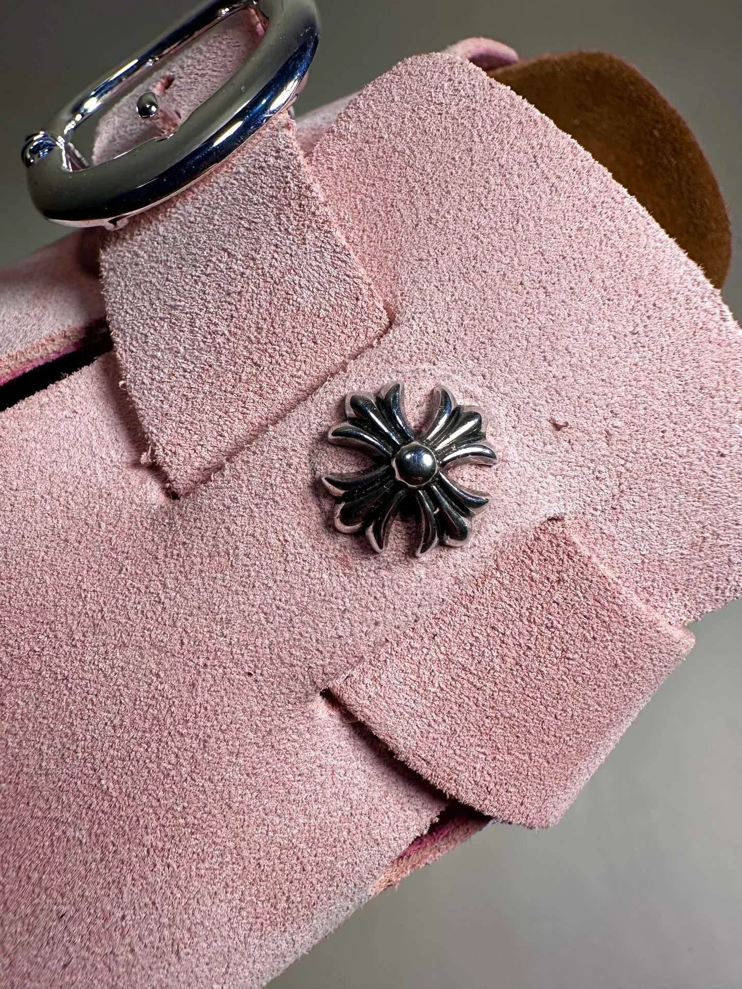 Деталь серебряной заклепки в виде креста на розовой замше сабо Chrome Hearts x Birkenstock
