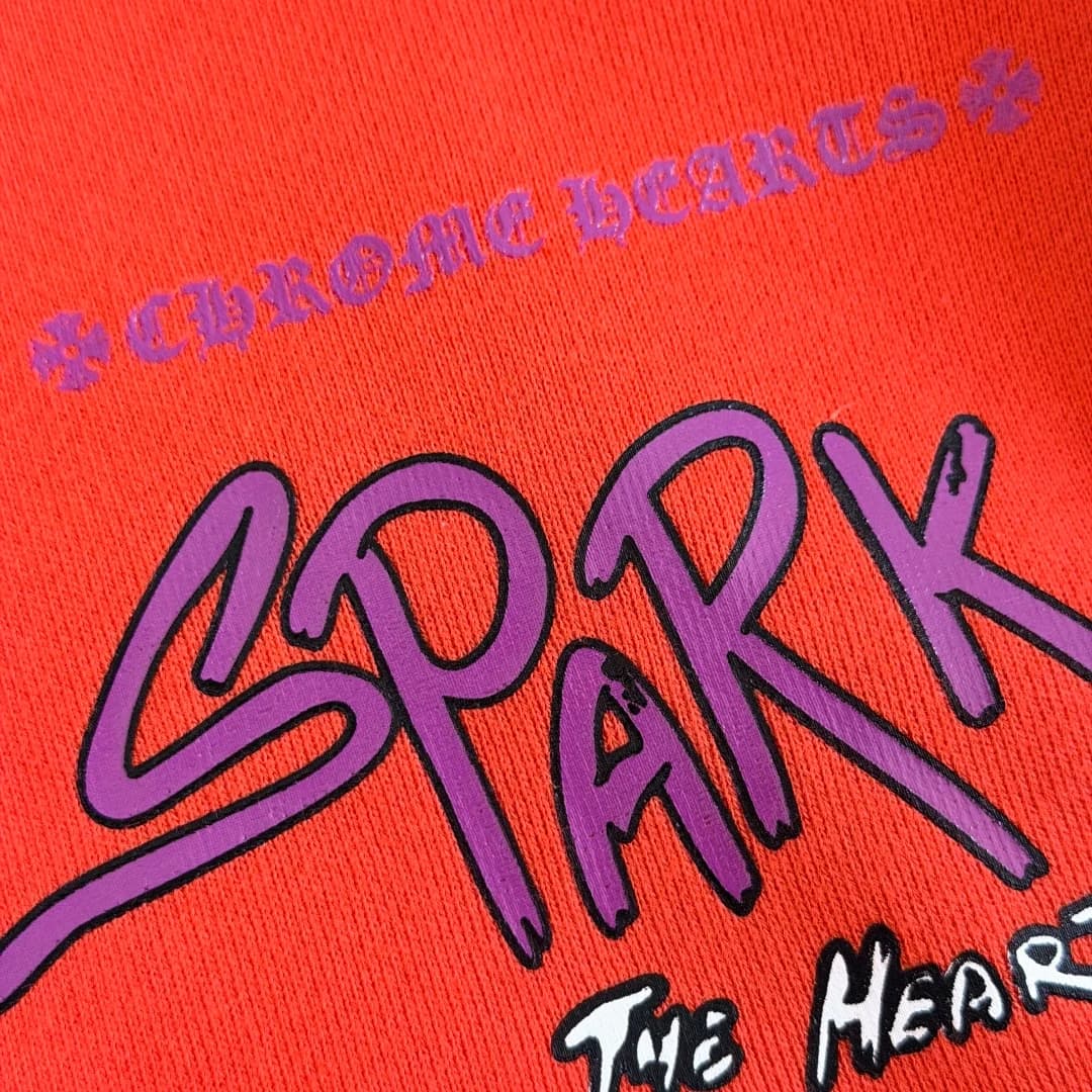 Фиолетовый логотип и надпись Spark The Heart крупным планом