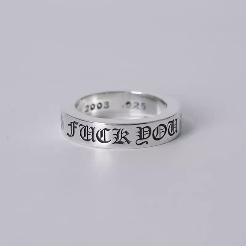 Серебряное кольцо с готической гравировкой Fuck You, вид сбоку на белом фоне