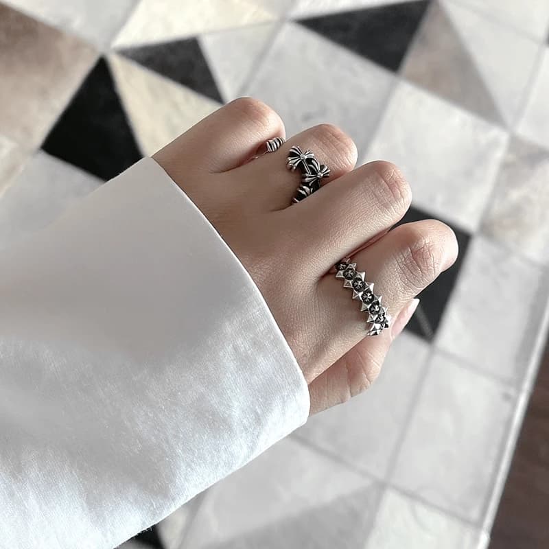 Сет из серебряных колец с готическими крестами на пальцах руки крупным планом