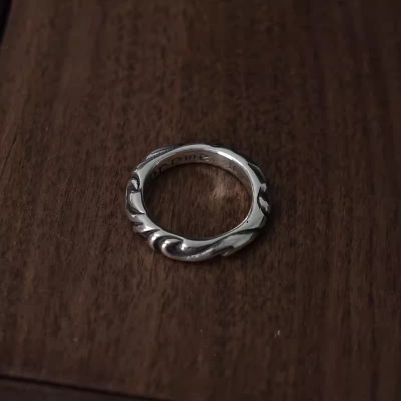 Серебристое кольцо Scroll Band на тёмной деревянной поверхности