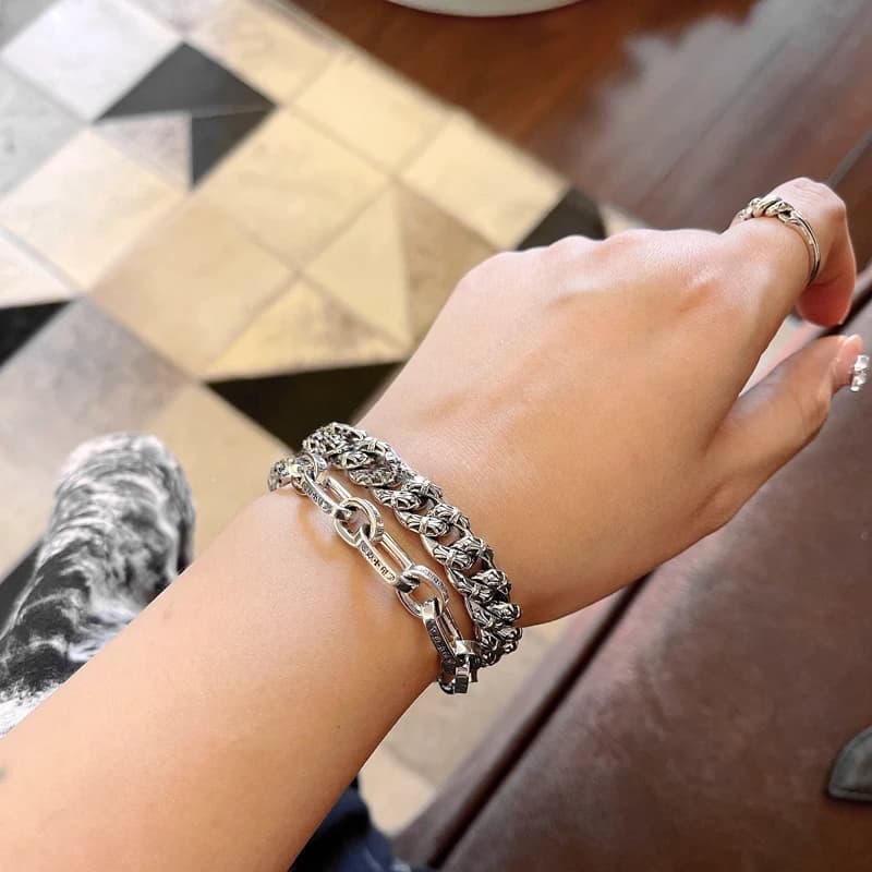 Сет из серебряного браслета Fancy и плоской цепи на руке, вид сверху